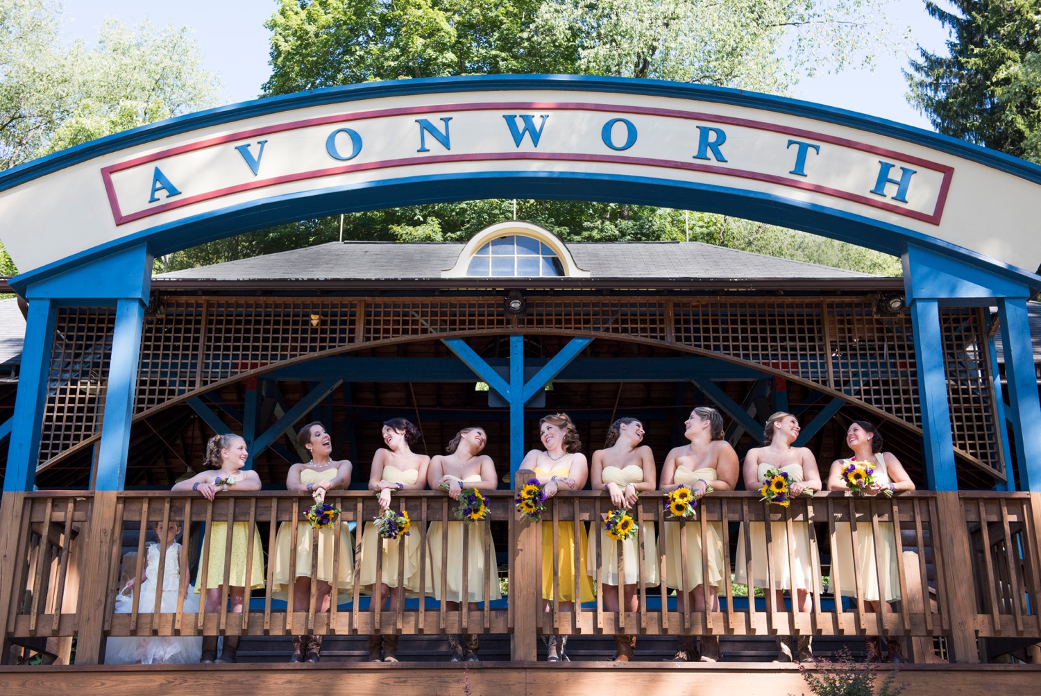large group of bridesmaids in yellow dresses and cowboy boots